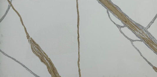 Close-up of a marble-like tile with gold and gray veins on a white background
